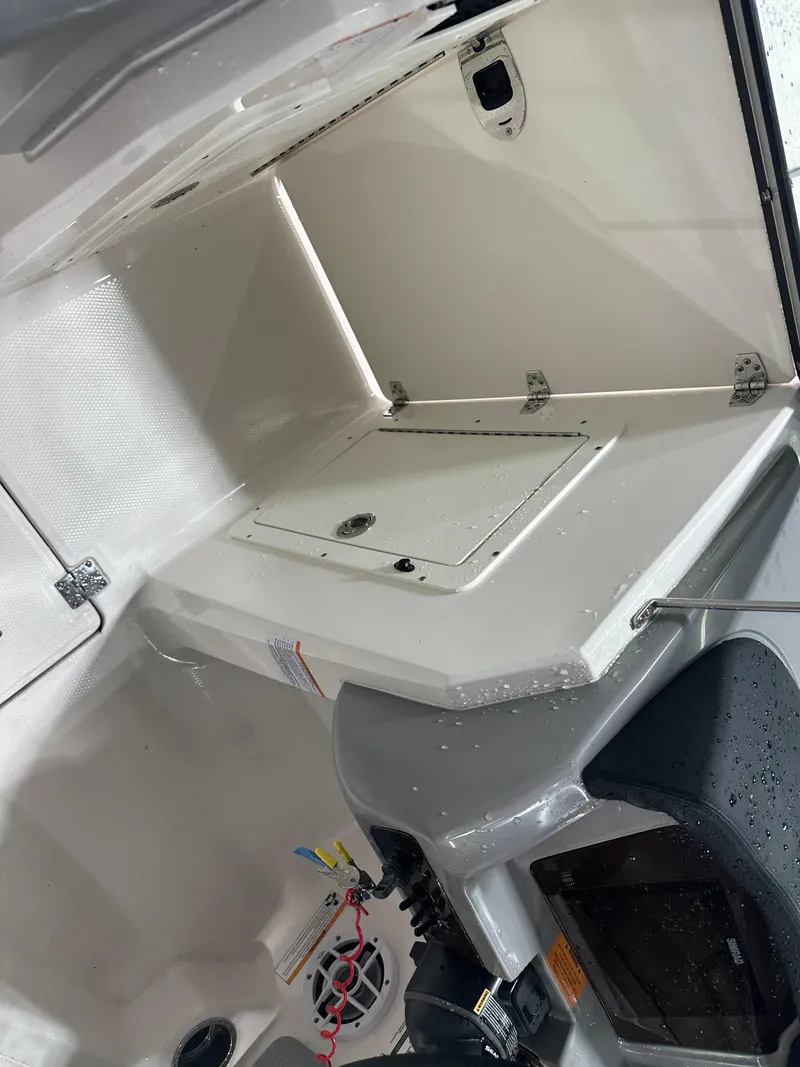 Slide: The Image of 2024 Chaparral SSI21SP boat interior storage compartment with wet surfaces. - 35