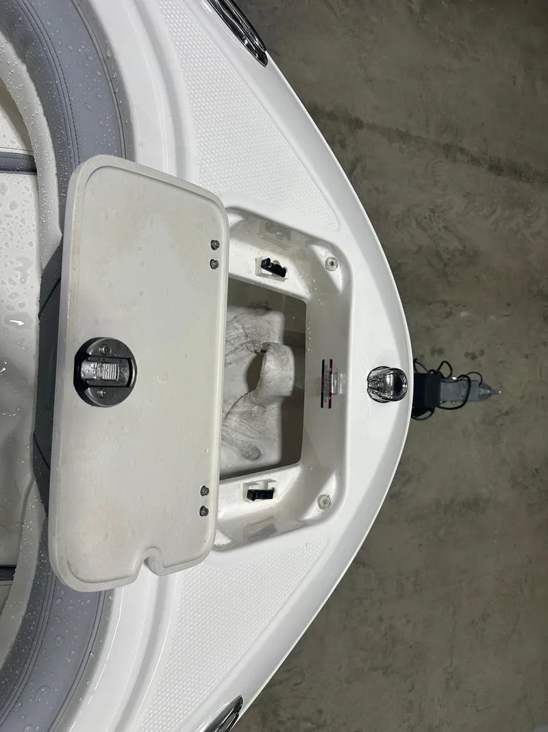 Slide: The Image of 2024 Chaparral SSI21SP boat anchor compartment, open lid, showing interior details. - 39