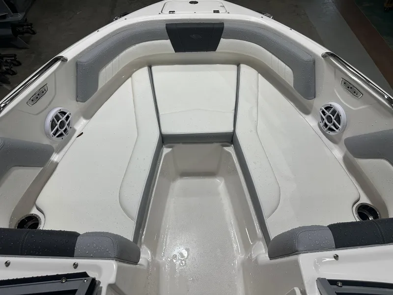 Slide: The Image of 2024 Chaparral SSI21SP boat interior with cushioned seating and speakers. - 41
