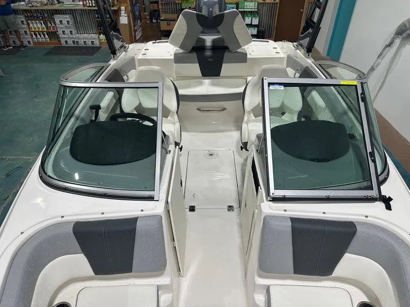 Slide: The Image of 2024 Chaparral SSI21SP boat interior with seating and windshield in showroom. - 43