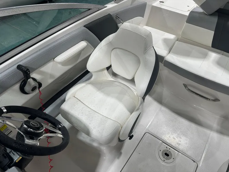 Slide: The Image of 2024 Chaparral SSI21SP boat interior with white captain's seat and steering wheel. - 47