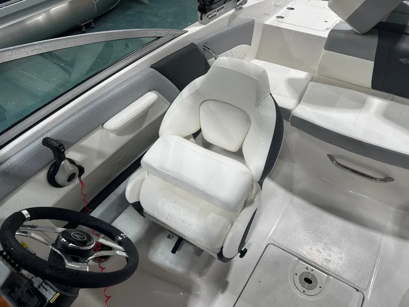 Slide: The Image of 2024 Chaparral SSI21SP boat interior with white captain's seat and steering wheel. - 48