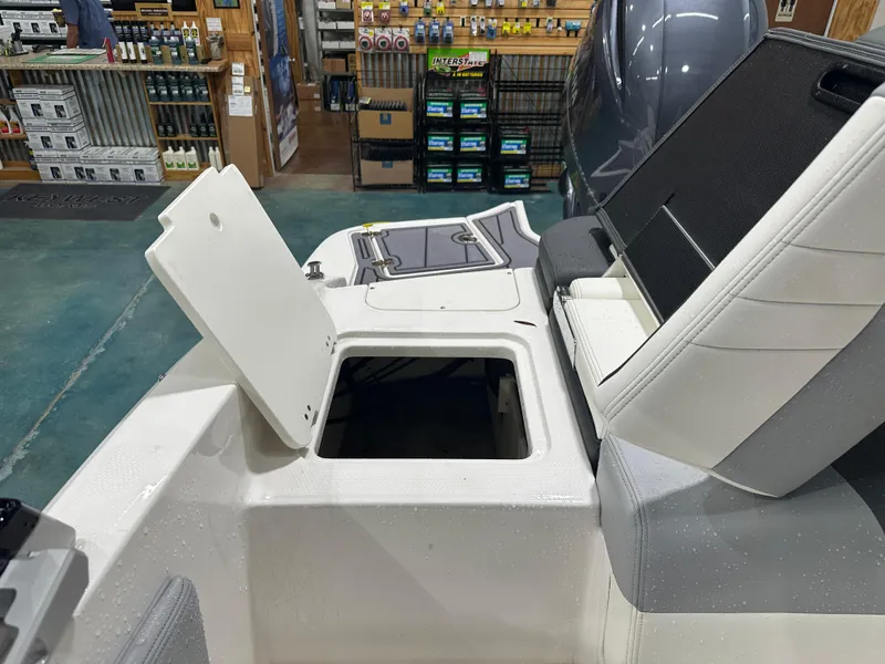 Slide: The Image of 2024 Chaparral SSI21SP boat interior with open storage compartment in showroom. - 49