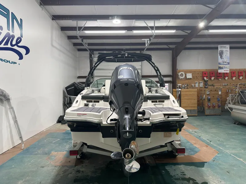 Slide: The Image of 2024 Chaparral SSI21SP boat in showroom, rear view with outboard motor. - 7