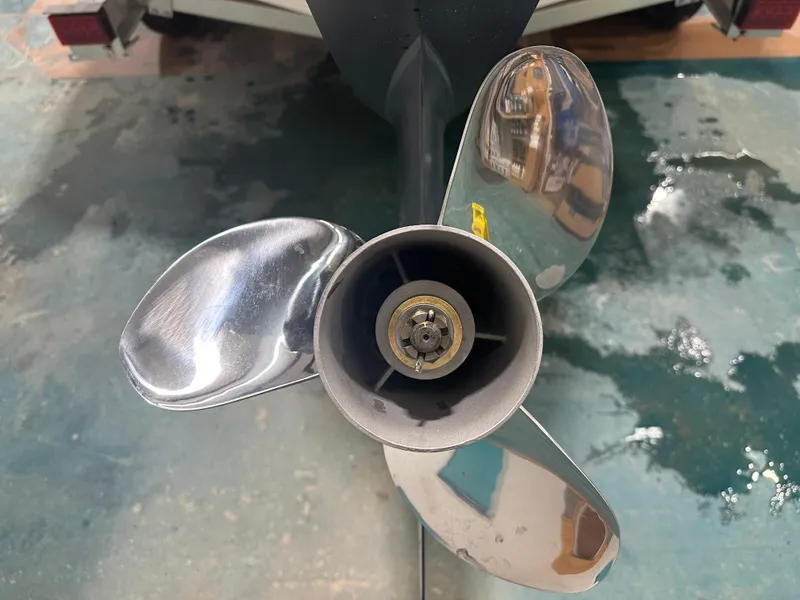 Slide: The Image of 2024 Chaparral SSI21SP boat propeller, shiny metal blades, close-up view. - 8