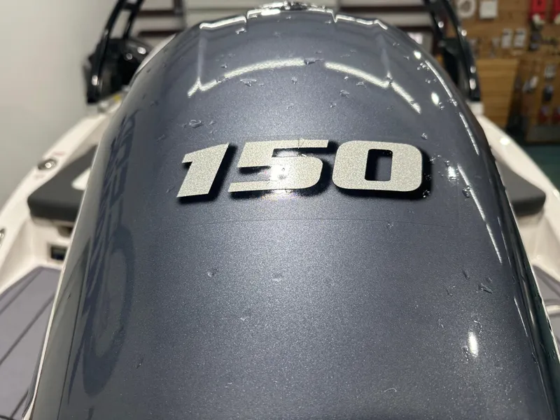 Slide: The Image of 2024 Chaparral SSI21SP boat engine cover with "150" emblem. - 9