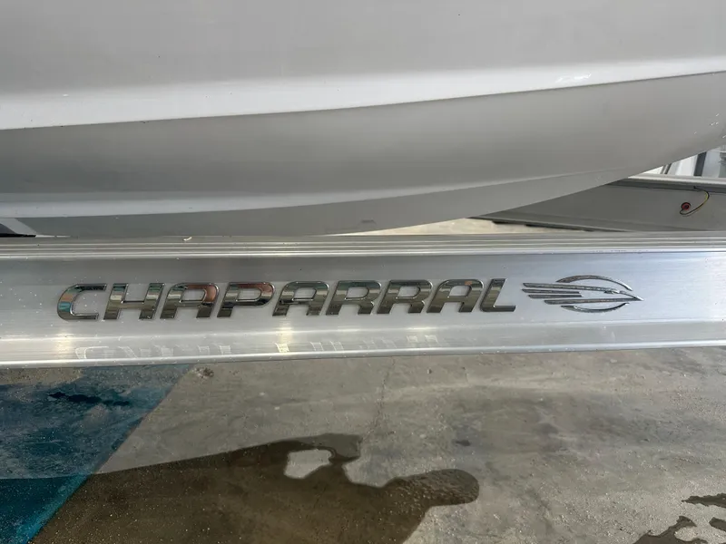 Slide: The Image of 2024 Chaparral SSI23SP boat logo on metallic surface. - 10