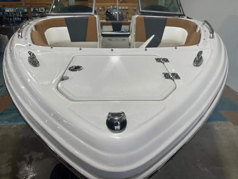 Slide: The Image of 2024 Chaparral SSI23SP boat interior, featuring sleek white and tan seating. - 11