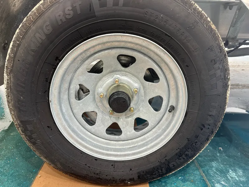 Slide: The Image of 2024 Chaparral SSI23SP trailer tire and wheel, close-up view. - 13