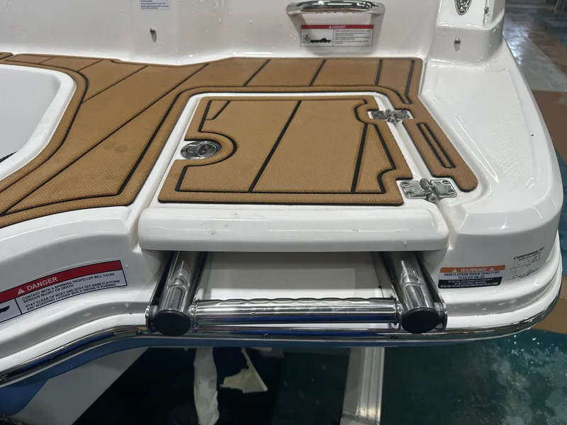 Slide: The Image of 2024 Chaparral SSI23SP boat swim platform with teak-style decking and retractable ladder. - 14