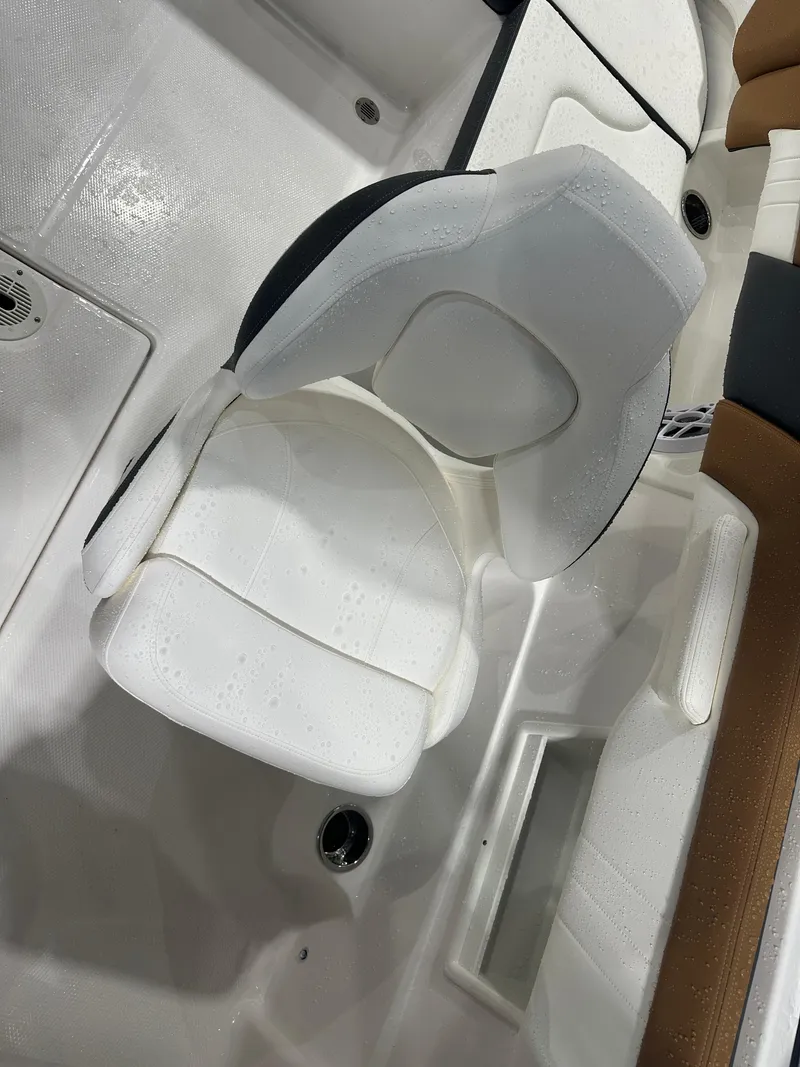 Slide: The Image of 2024 Chaparral SSI23SP boat interior with white cushioned seating. - 32