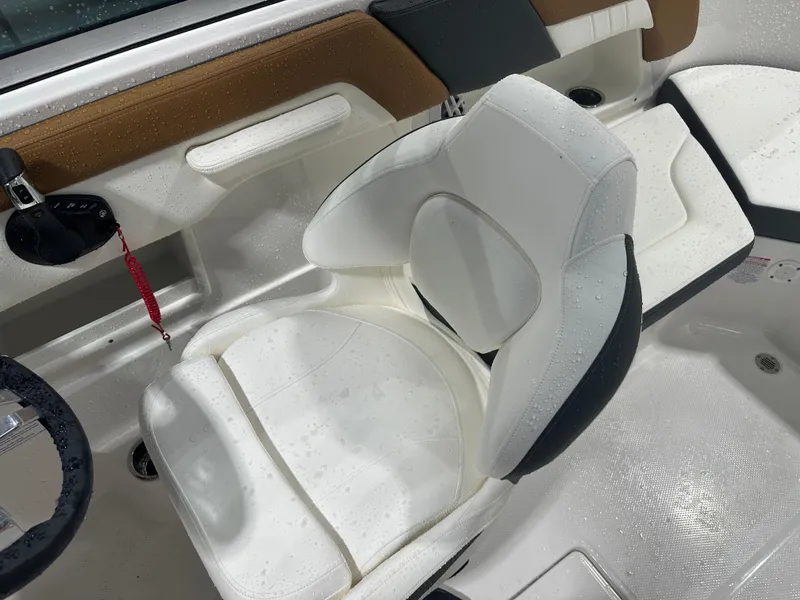 Slide: The Image of 2024 Chaparral SSI23SP boat interior with white cushioned seat and steering wheel. - 34