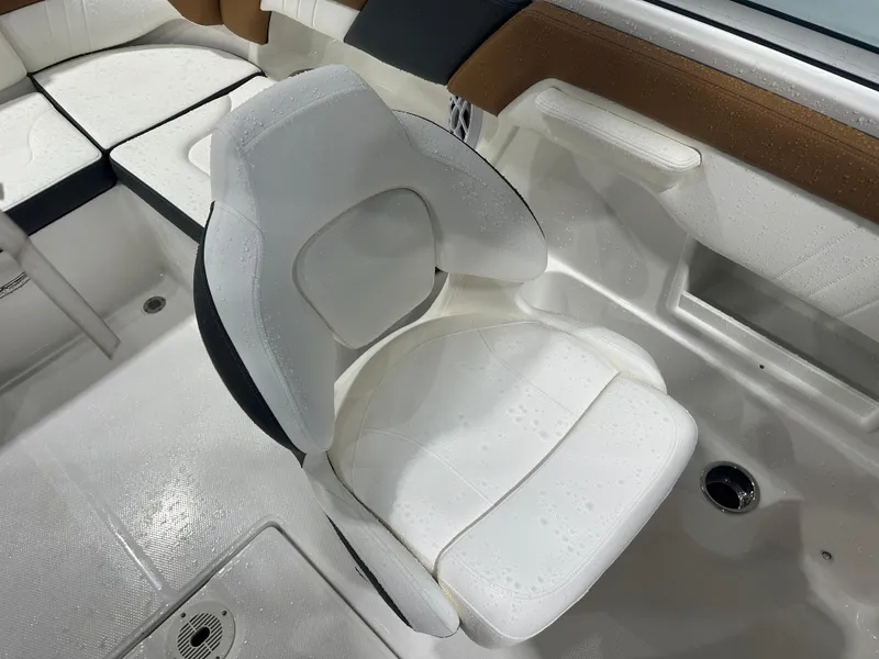 Slide: The Image of 2024 Chaparral SSI23SP boat interior with white seating and brown accents. - 35