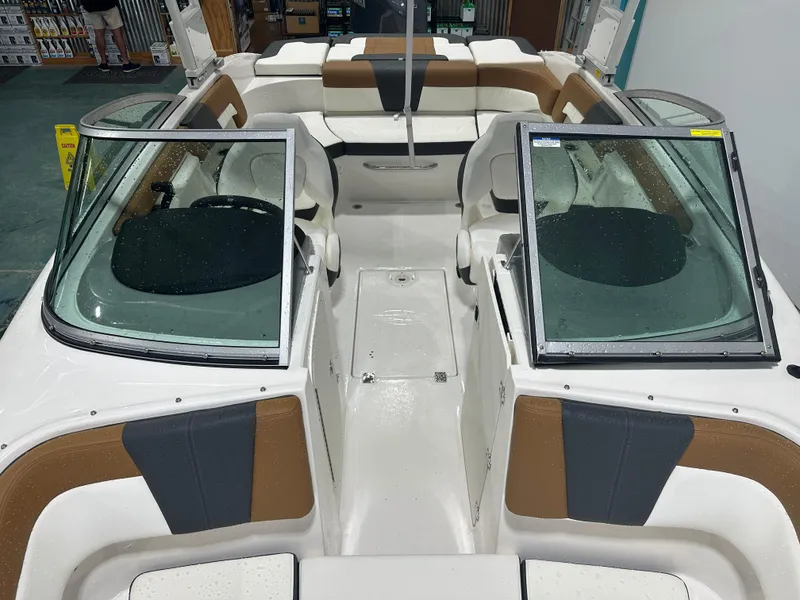 Slide: The Image of 2024 Chaparral SSI23SP boat interior with open windshield and seating. - 39