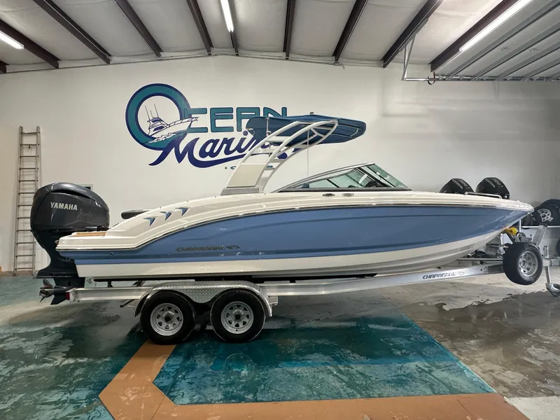 Slide: The Image of 2024 Chaparral SSI23SP boat in showroom, featuring Yamaha engine, on trailer. - 5
