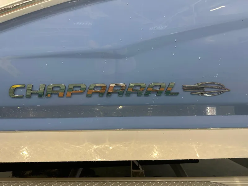 Slide: The Image of 2024 Chaparral SSI23SP boat logo on blue hull with water droplets. - 8