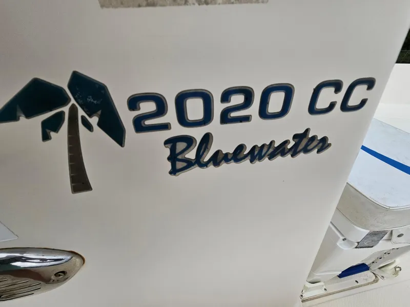 Slide: The Image of Key West 2020CC Bluewater boat logo, 2005 model, featuring palm tree design. - 13