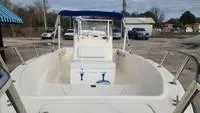 Slide: The Image of Key West 2020CC 2005 boat with center console and blue canopy in a parking lot. - 14
