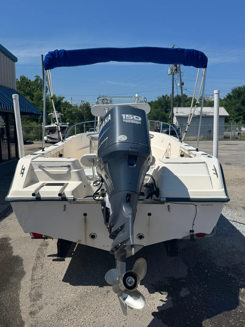 Slide: The Image of Key West 2020CC 2005 boat with Yamaha 150 engine, parked outdoors. - 17