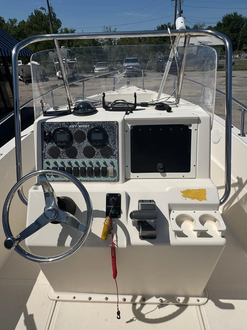 Slide: The Image of Center console of a 2005 Key West 2020CC boat with steering wheel and controls. - 18