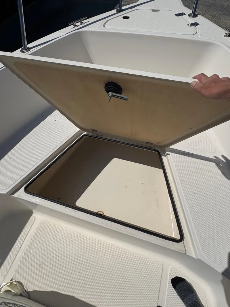 Slide: The Image of Open storage compartment on a 2005 Key West 2020CC boat deck. - 19