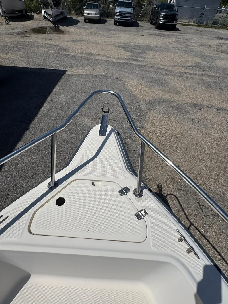 Slide: The Image of Bow of 2005 Key West 2020CC boat in parking lot with vehicles. - 20