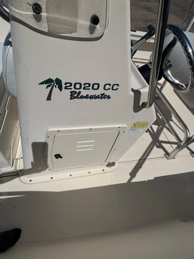 Slide: The Image of Key West 2020CC Bluewater boat console, 2005 model, featuring steering wheel and storage compartment. - 21