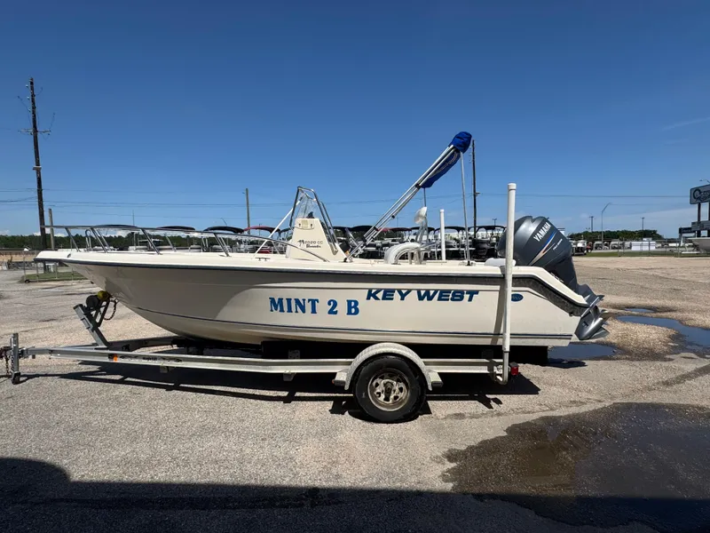 Slide: The Image of 2005 Key West 2020CC boat on trailer, labeled "MINT 2 B," parked outdoors. - 22