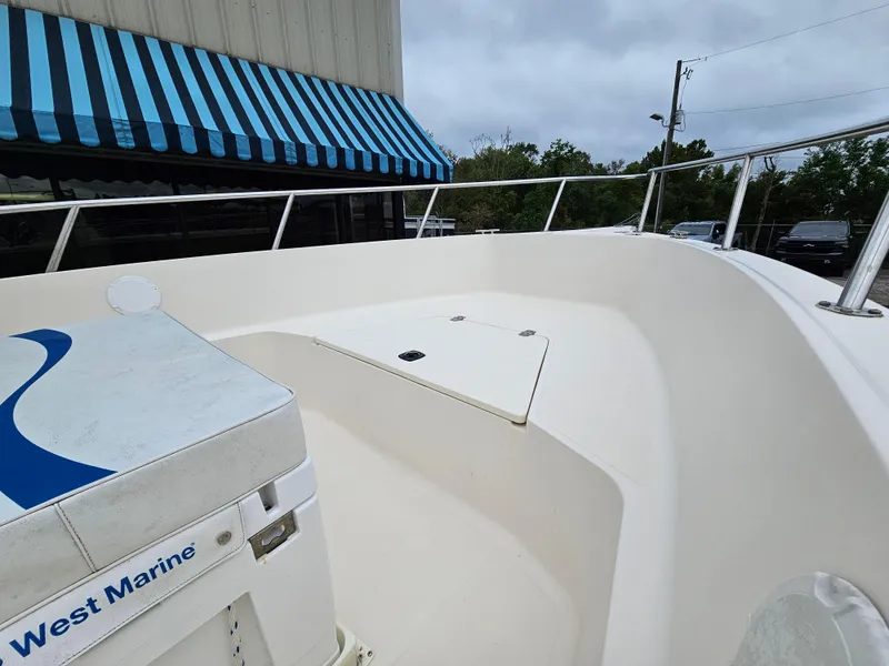 Slide: The Image of Key West 2020CC boat interior, 2005 model, with blue-striped awning in background. - 6