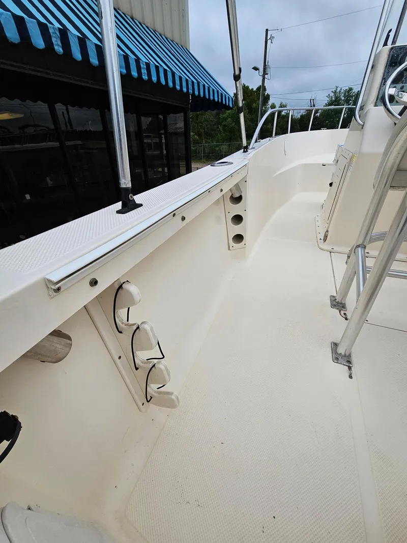 Slide: The Image of Key West 2020CC 2005 boat interior with rod holders and clean deck. - 7
