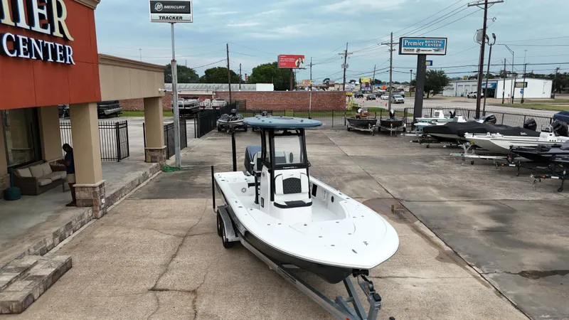 Slide: The Image of 2023 Tidewater 2410BM boat displayed at a dealership with other boats in the background. - 10