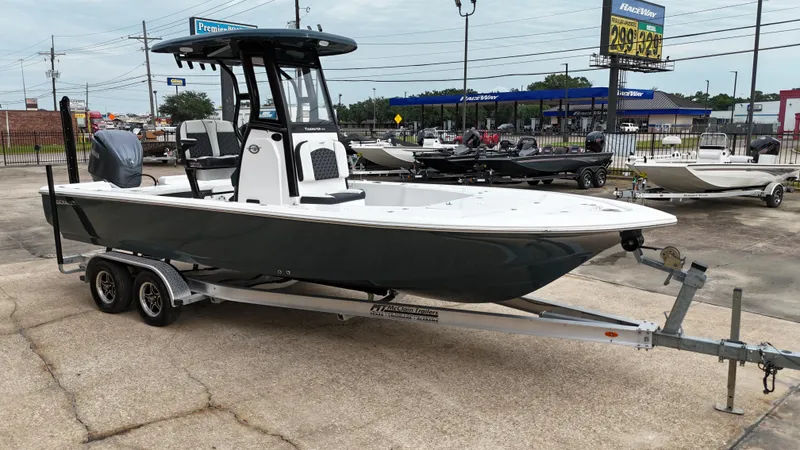 Slide: The Image of 2023 Tidewater 2410BM boat on trailer in dealership lot. - 12