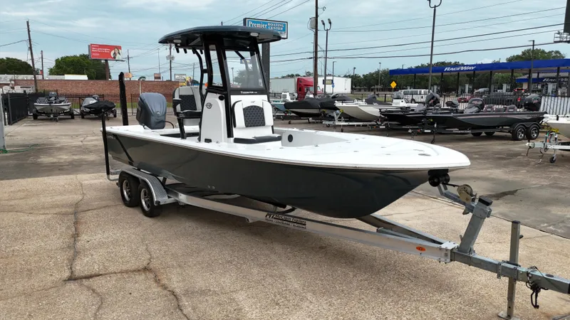 Slide: The Image of 2023 Tidewater 2410BM boat on trailer in outdoor dealership lot. - 13