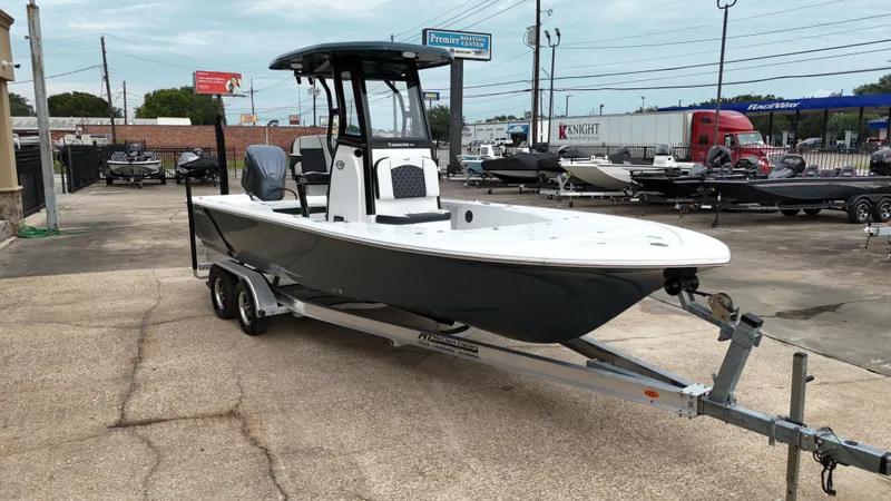 Slide: The Image of 2023 Tidewater 2410BM boat on trailer in parking lot. - 14