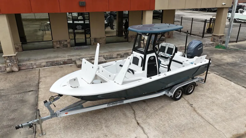 Slide: The Image of 2023 Tidewater 2410BM boat on trailer outside dealership. - 23