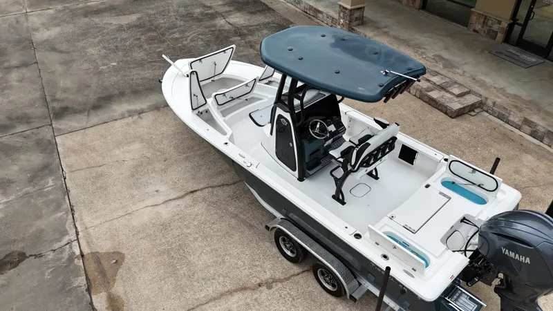 Slide: The Image of 2023 Tidewater 2410BM boat on trailer, aerial view, parked on concrete surface. - 25
