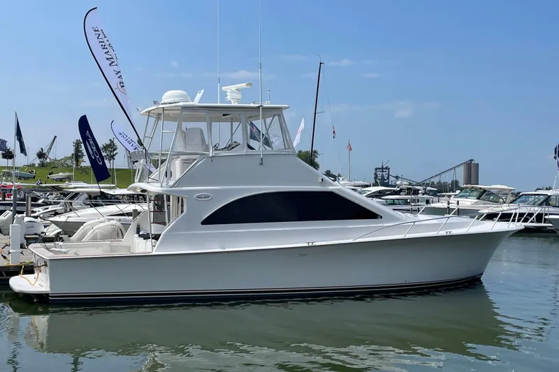 Slide: The Image of 2000 Ocean Yachts 48 Super Sport docked at marina under clear blue sky. - 0