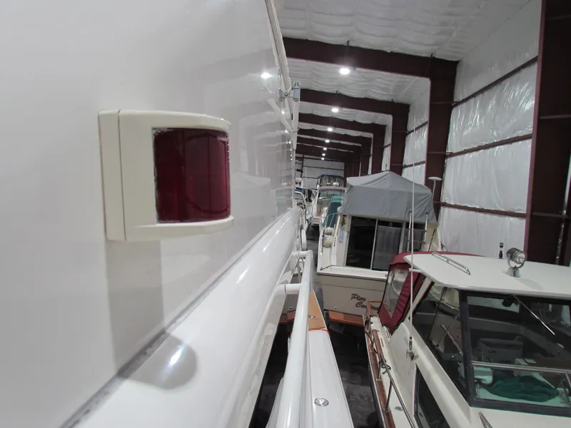 Slide: The Image of 2000 Ocean Yachts 48 Sun Sport in storage, side view of sleek design. - 13