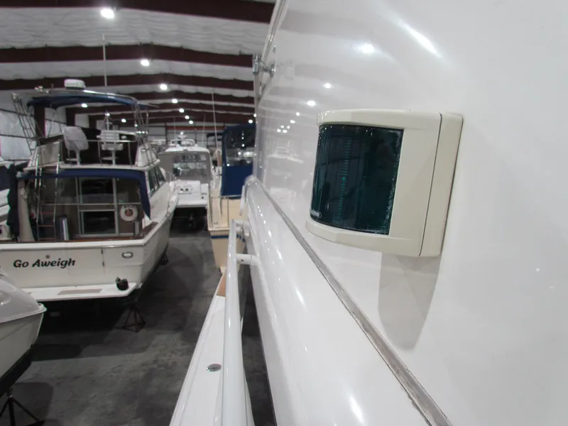 Slide: The Image of Ocean Yachts 48 Sun Sport 2000 in storage, side view with navigation light. - 14