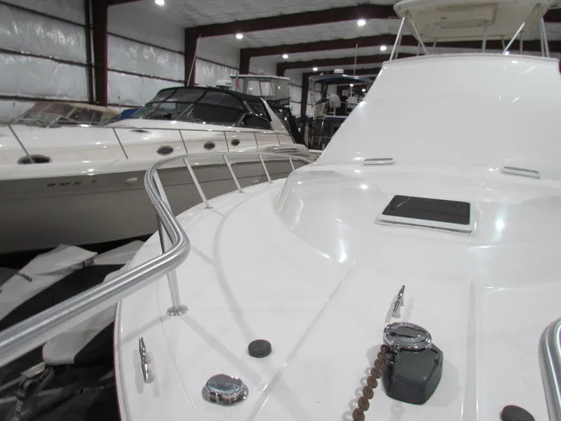 Slide: The Image of 2000 Ocean Yachts 48 Sun Sport in indoor storage, sleek white design. - 16