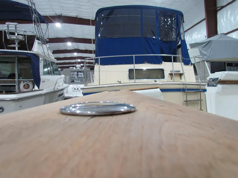 Slide: The Image of Ocean Yachts 48 Sun Sport 2000 in indoor storage, surrounded by other boats. - 19