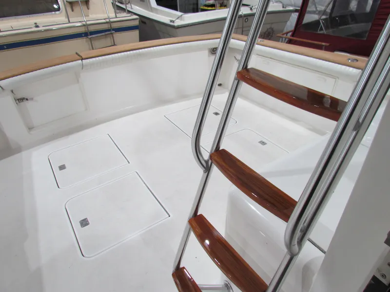 Slide: The Image of Ocean Yachts 48 Sun Sport 2000 model, featuring a sleek deck and polished ladder. - 24
