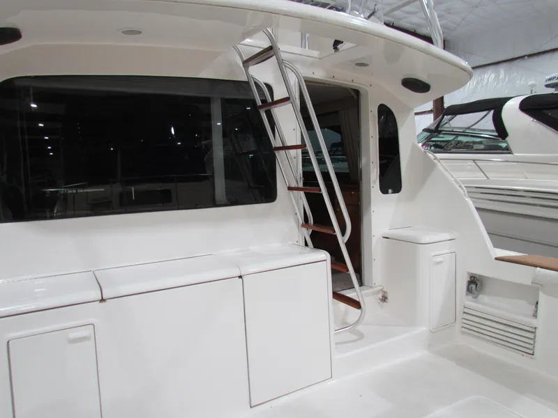 Slide: The Image of 2000 Ocean Yachts 48 Sun Sport yacht interior with sleek white design and ladder access. - 31