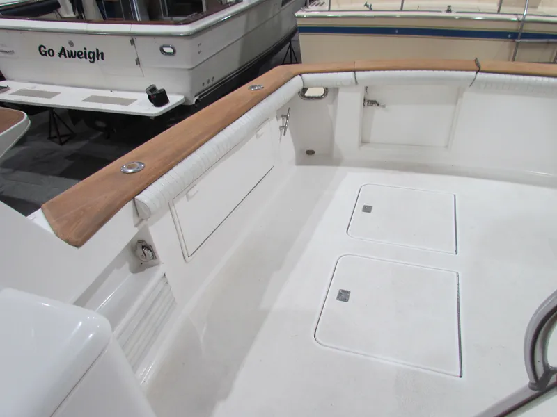 Slide: The Image of 2000 Ocean Yachts 48 Sun Sport boat deck with wood trim and storage compartments. - 32