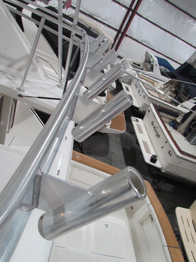 Slide: The Image of 2000 Ocean Yachts 48 Sun Sport with rod holders in a marina. - 35