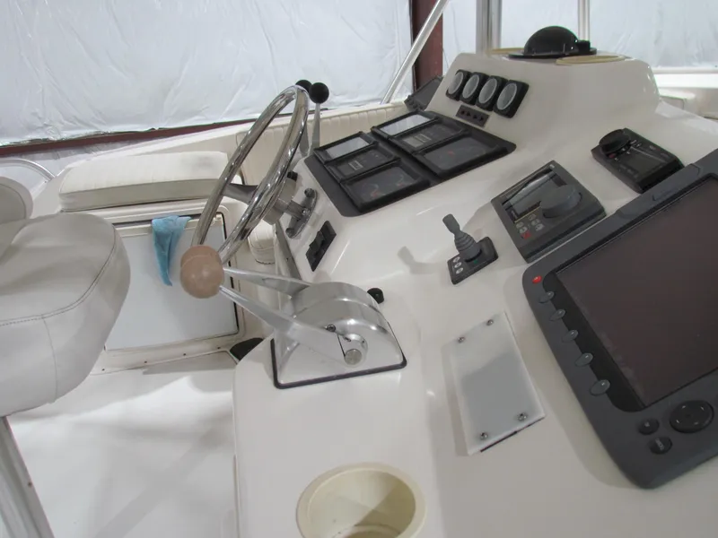 Slide: The Image of Cockpit of 2000 Ocean Yachts 48 Sun Sport with steering wheel and navigation controls. - 38