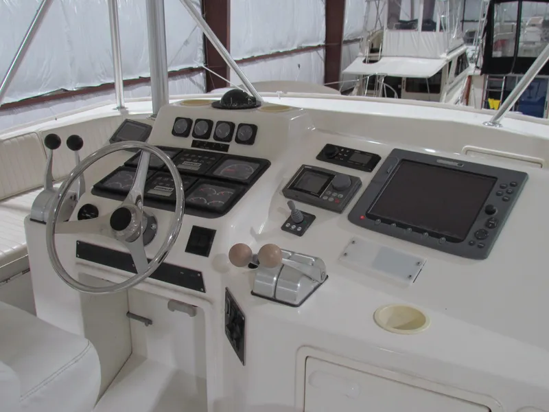 Slide: The Image of Cockpit of 2000 Ocean Yachts 48 Sun Sport with steering wheel and navigation controls. - 4
