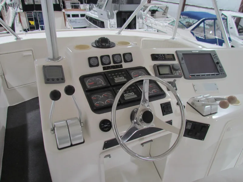 Slide: The Image of Control panel of a 2000 Ocean Yachts 48 Sun Sport boat, featuring steering wheel and gauges. - 41
