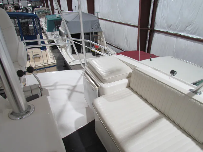 Slide: The Image of 2000 Ocean Yachts 48 Sun Sport interior with white seating in a boat storage facility. - 44