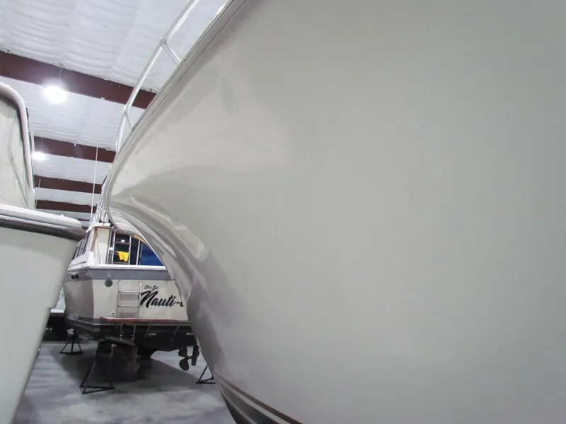 Slide: The Image of Ocean Yachts 48 Sun Sport 2000 in storage, sleek hull design, indoor facility. - 9